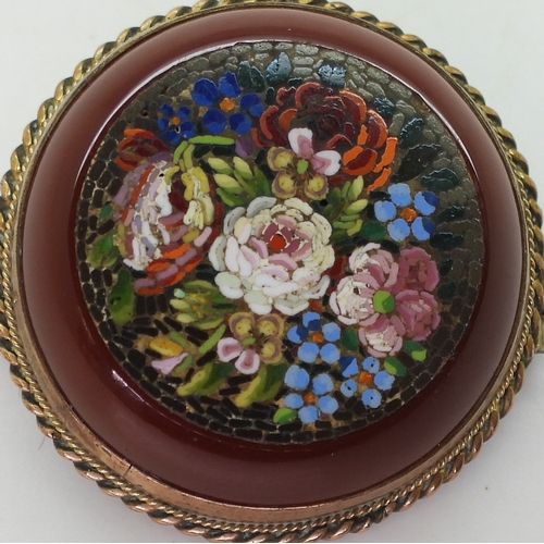 2804 - A MICRO MOSAIC BROOCHdepicting flowers set into a carved carnelian rondel. With a yellow metal mount... 