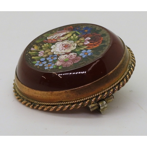 2804 - A MICRO MOSAIC BROOCHdepicting flowers set into a carved carnelian rondel. With a yellow metal mount... 