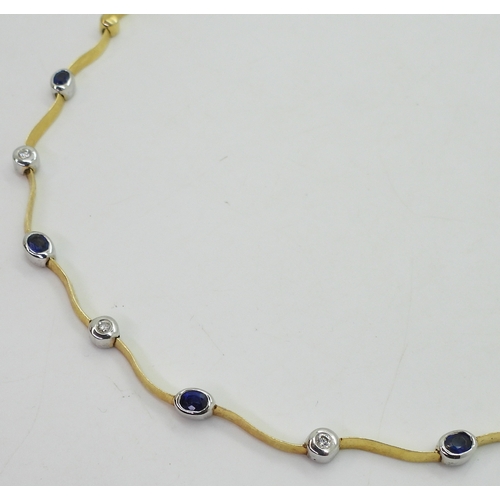 2805 - A SAPPHIRE AND DIAMOND NECKLACEthe necklace with wave shaped links and set with four oval cut sapphi... 