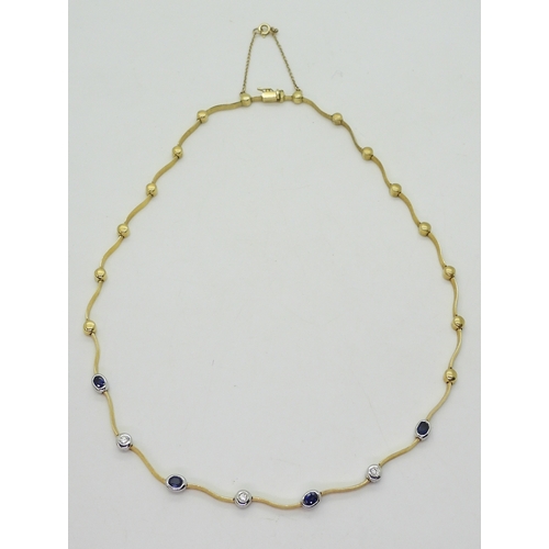 2805 - A SAPPHIRE AND DIAMOND NECKLACEthe necklace with wave shaped links and set with four oval cut sapphi... 