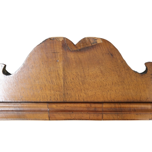 2004 - A GEORGIAN WALNUT VENEERED WALL MIRRORwith fret cut scrolled frame, 94cm high x 55cm wide... 