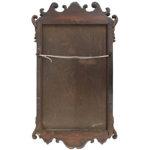 2004 - A GEORGIAN WALNUT VENEERED WALL MIRRORwith fret cut scrolled frame, 94cm high x 55cm wide... 