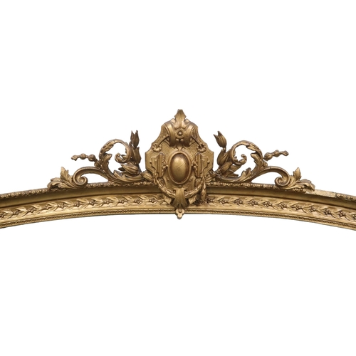 2011 - A LATE 19TH CENTURY GILT GESSO ROCOCO STYLE OVERMANTLE MIRRORwith scrolled surmount over arched fram... 