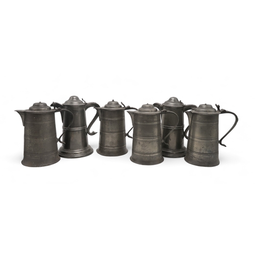 2260 - A COLLECTION OF CHURCH PEWTERincluding a pair of communion jugs, 32cm high,  a pair of goblets, 22cm... 