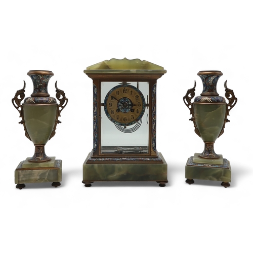 2267 - A FRENCH CHAMPLEVE ENAMEL AND ONYX CLOCK GARNITUREthe clock of rectangular form with gilded dial, bl... 