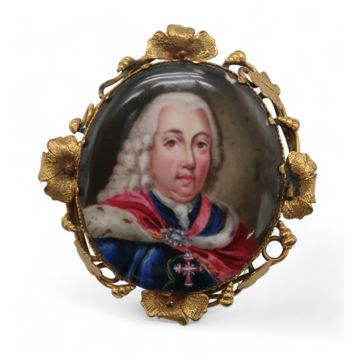 2269 - A PAINTED ENAMEL MINIATUREpurportedly King Joao V of Portugal, in gilded metal brooch surround, 4.5c... 