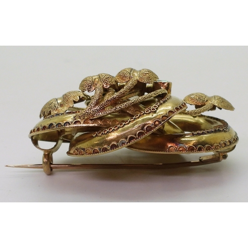 2809 - A VICTORIAN BROOCH the knot form with applied wire work details, is made in yellow metal and se... 