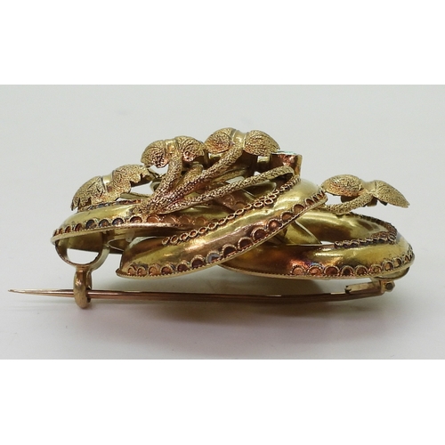 2809 - A VICTORIAN BROOCH the knot form with applied wire work details, is made in yellow metal and se... 