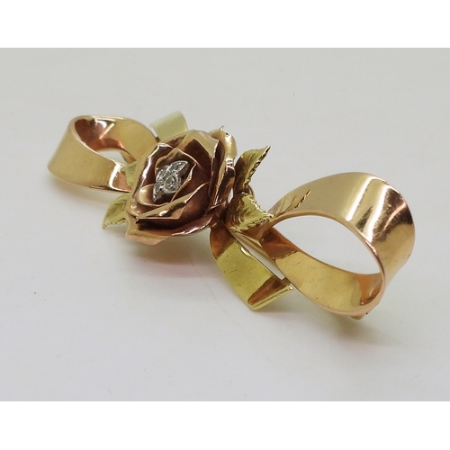 2812 - A 14K TRICOLOUR GOLD BROOCHwith rose motif in rose gold the centre set with diamond accents. Length ... 