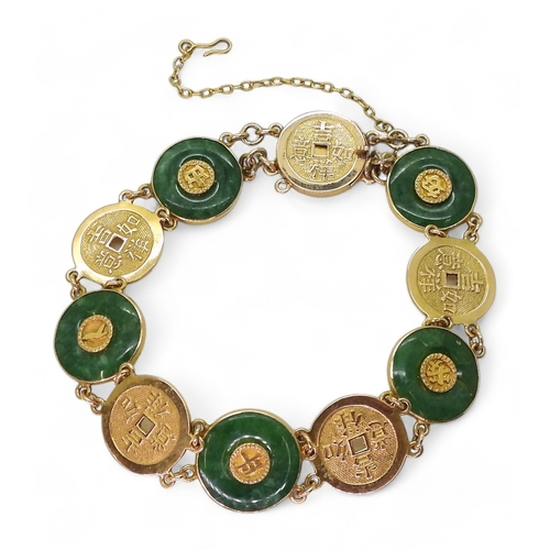 2814 - A CHINESE GREEN HARDSTONE BRACELETalternate rondels set with hardstone, with Chinese symbols through... 