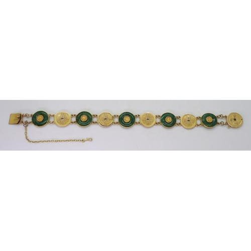 2814 - A CHINESE GREEN HARDSTONE BRACELETalternate rondels set with hardstone, with Chinese symbols through... 