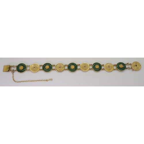 2814 - A CHINESE GREEN HARDSTONE BRACELETalternate rondels set with hardstone, with Chinese symbols through... 