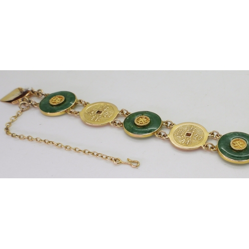 2814 - A CHINESE GREEN HARDSTONE BRACELETalternate rondels set with hardstone, with Chinese symbols through... 