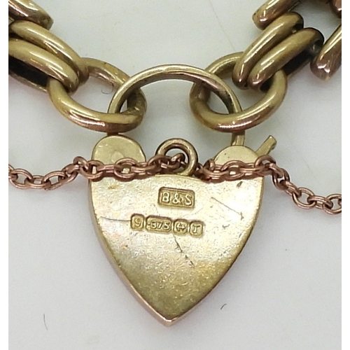 2815 - A 9CT GATE BRACELETwith decorative links and a heart shaped clasp, length 18.5cm, weight 15.8gms... 