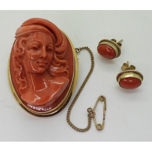 2826 - A CORAL CAMEO BROOCHthe well carved high relief cameo of a maiden is in a 18ct gold pendant brooch m... 