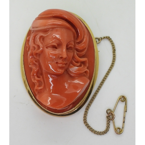 2826 - A CORAL CAMEO BROOCHthe well carved high relief cameo of a maiden is in a 18ct gold pendant brooch m... 