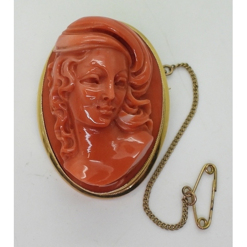 2826 - A CORAL CAMEO BROOCHthe well carved high relief cameo of a maiden is in a 18ct gold pendant brooch m... 