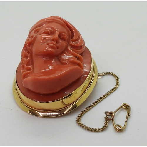 2826 - A CORAL CAMEO BROOCHthe well carved high relief cameo of a maiden is in a 18ct gold pendant brooch m... 