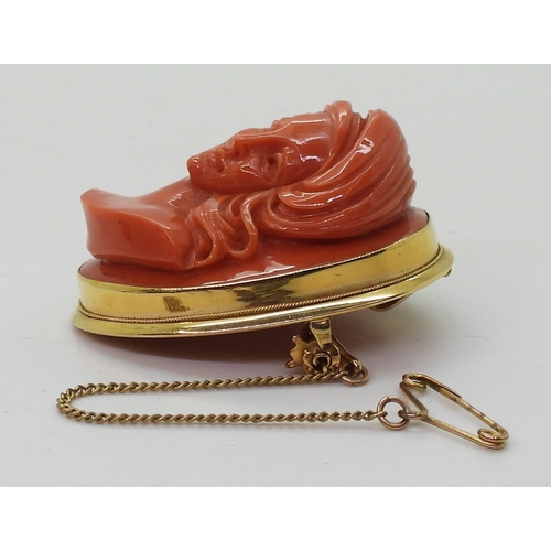 2826 - A CORAL CAMEO BROOCHthe well carved high relief cameo of a maiden is in a 18ct gold pendant brooch m... 