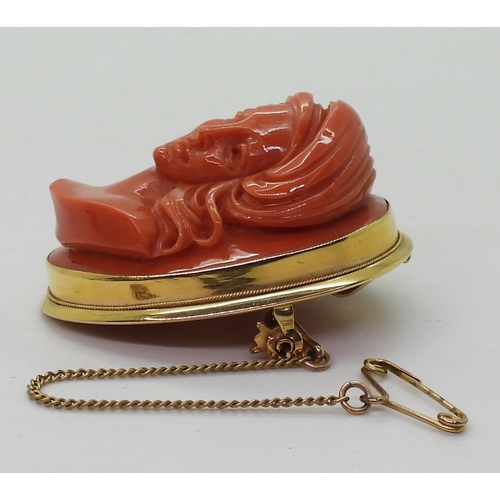 2826 - A CORAL CAMEO BROOCHthe well carved high relief cameo of a maiden is in a 18ct gold pendant brooch m... 