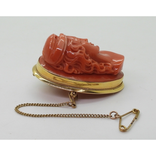 2826 - A CORAL CAMEO BROOCHthe well carved high relief cameo of a maiden is in a 18ct gold pendant brooch m... 