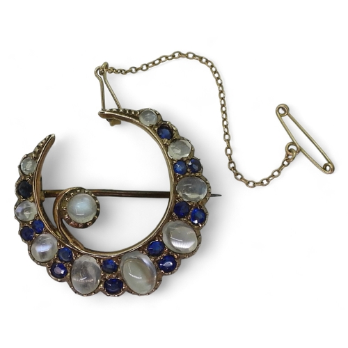 2831 - A CRESCENT BROOCHset with moonstone & blue paste to the yellow metal galleried mount, diameter a... 