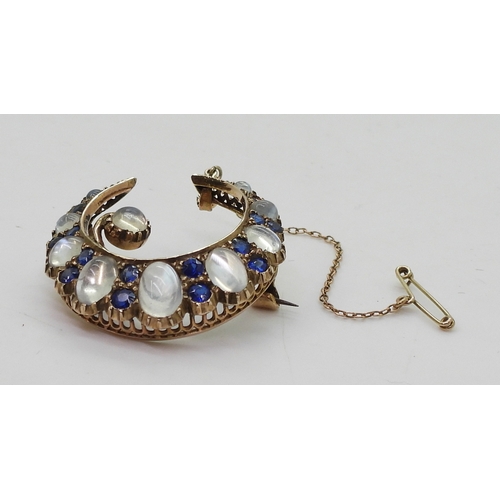 2831 - A CRESCENT BROOCHset with moonstone & blue paste to the yellow metal galleried mount, diameter a... 