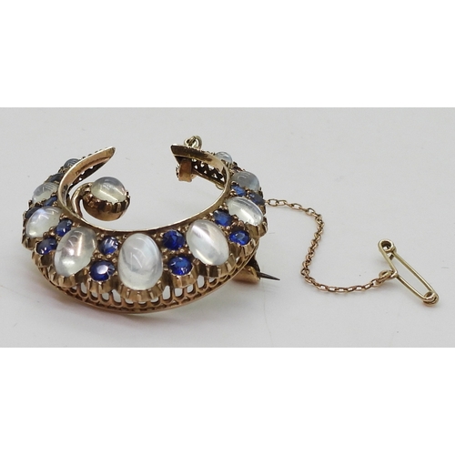 2831 - A CRESCENT BROOCHset with moonstone & blue paste to the yellow metal galleried mount, diameter a... 