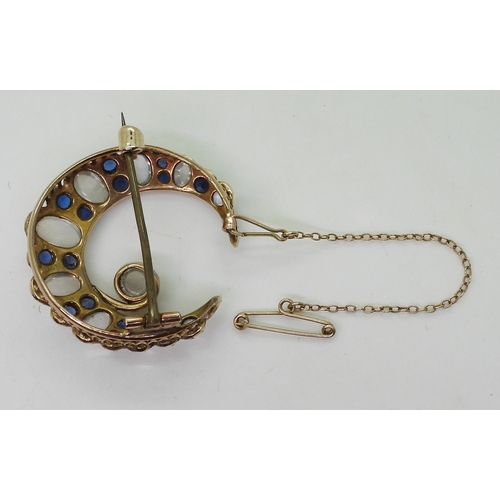 2831 - A CRESCENT BROOCHset with moonstone & blue paste to the yellow metal galleried mount, diameter a... 