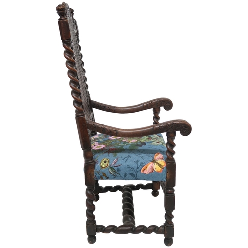 2017 - A 17TH CENTURY STYLE OAK BARLEY TWIST ARMCHAIR with cane back framed by carved pierced decoration fl... 