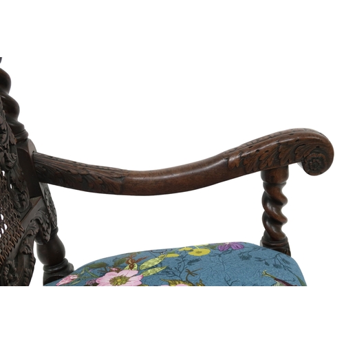 2017 - A 17TH CENTURY STYLE OAK BARLEY TWIST ARMCHAIR with cane back framed by carved pierced decoration fl... 