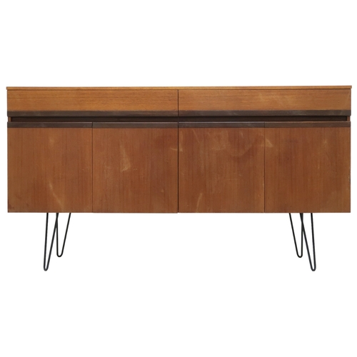 2076 - A MID 20TH CENTURY G PLAN SIDEBOARD with two long drawers over four cabinet doors on later hair... 