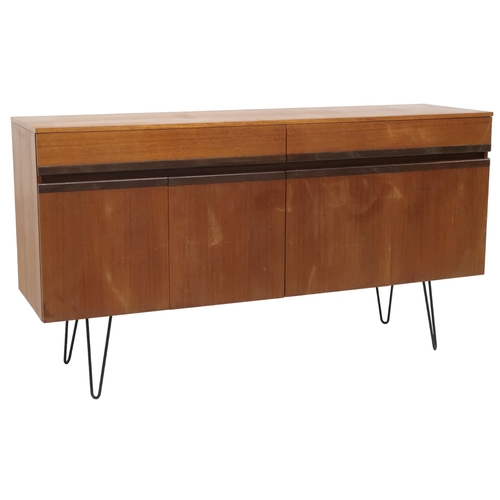 2076 - A MID 20TH CENTURY G PLAN SIDEBOARD with two long drawers over four cabinet doors on later hair... 