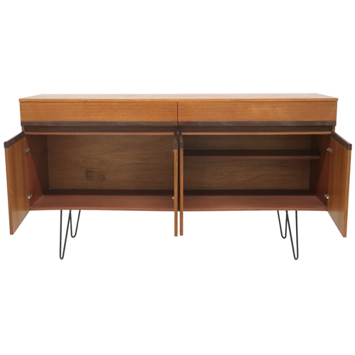 2076 - A MID 20TH CENTURY G PLAN SIDEBOARD with two long drawers over four cabinet doors on later hair... 