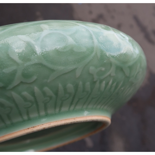 2405 - A CHINESE CELADON BOWLthe inner carved with a dragon and the outer carved with a ruyi band above mea... 