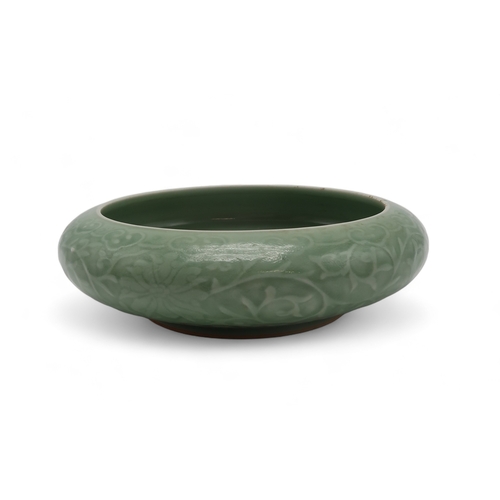 2405 - A CHINESE CELADON BOWLthe inner carved with a dragon and the outer carved with a ruyi band above mea... 