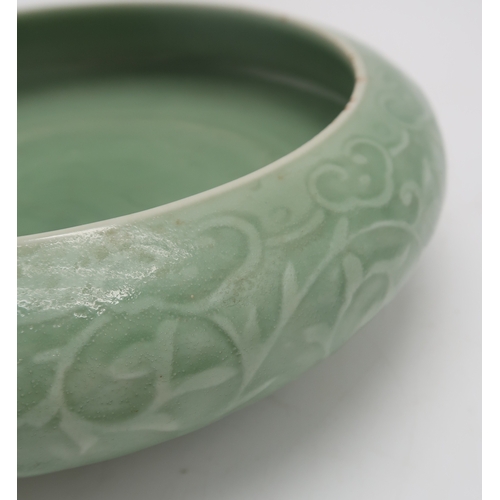 2405 - A CHINESE CELADON BOWLthe inner carved with a dragon and the outer carved with a ruyi band above mea... 