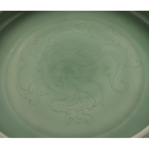 2405 - A CHINESE CELADON BOWLthe inner carved with a dragon and the outer carved with a ruyi band above mea... 