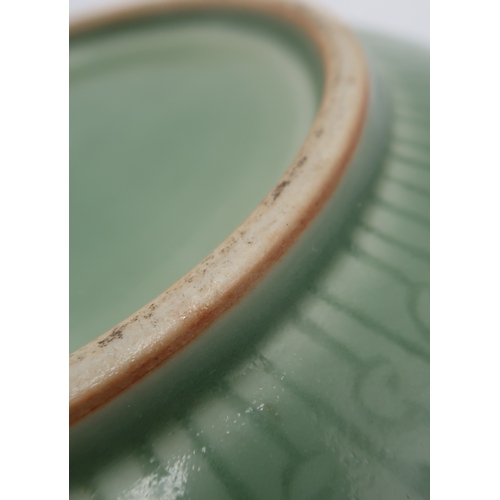 2405 - A CHINESE CELADON BOWLthe inner carved with a dragon and the outer carved with a ruyi band above mea... 