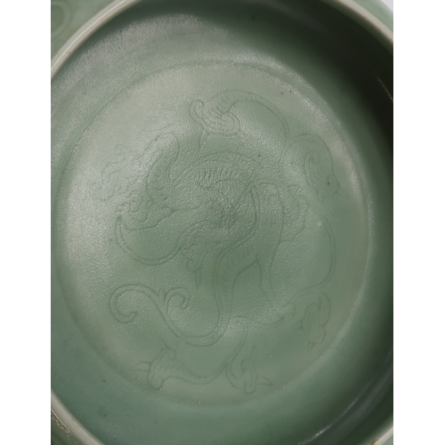 2405 - A CHINESE CELADON BOWLthe inner carved with a dragon and the outer carved with a ruyi band above mea... 