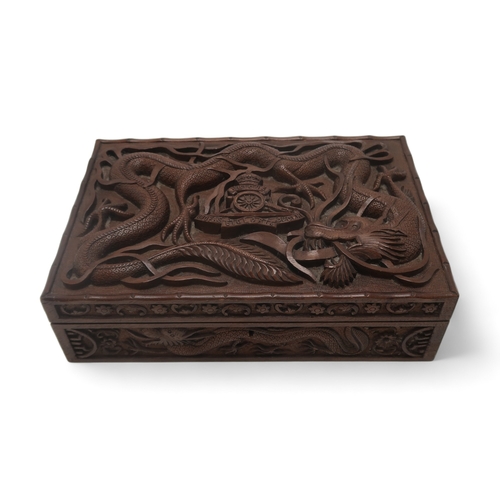 2406 -  A BURMESE MILITARY HARDWOOD CARVED CIGAR BOXwith Royal Artillery badge surrounded by dragons, the i... 