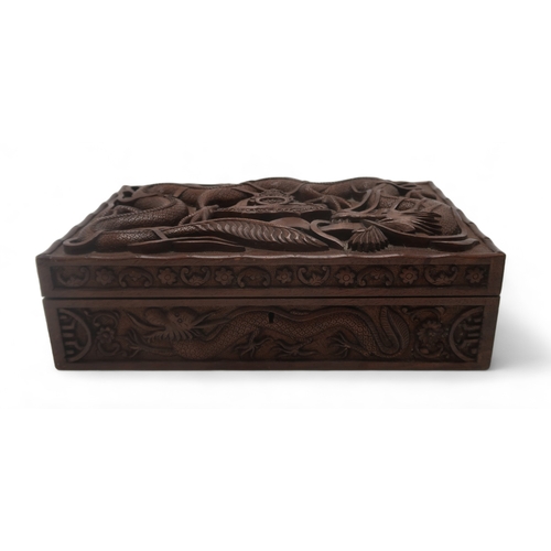 2406 -  A BURMESE MILITARY HARDWOOD CARVED CIGAR BOXwith Royal Artillery badge surrounded by dragons, the i... 