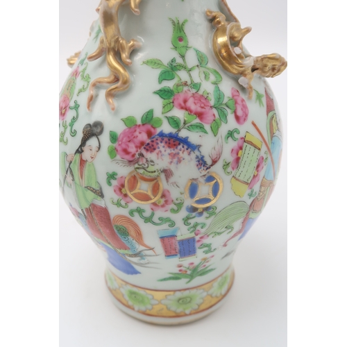 2409 - A CANTON BALUSTER VASE painted with various figures, animals, precious objects and applied with gilt... 