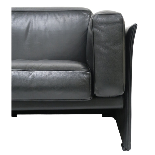 2084 - A 20TH CENTURY CASSINA THREE SEATER SETTEEwith black leather upholstered cushions on leather upholst... 