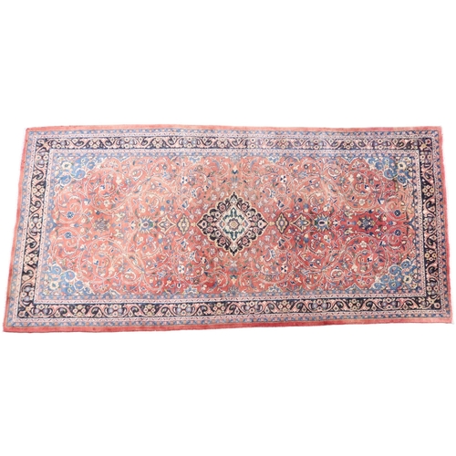 2123 - A TERRACOTTA GROUND FULL PILE PERSIAN SUROK RUNNER with dark central medallion and light blue s... 