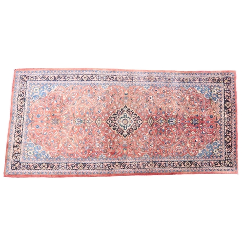 2123 - A TERRACOTTA GROUND FULL PILE PERSIAN SUROK RUNNER with dark central medallion and light blue s... 