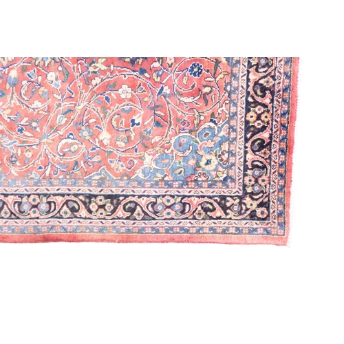 2123 - A TERRACOTTA GROUND FULL PILE PERSIAN SUROK RUNNER with dark central medallion and light blue s... 