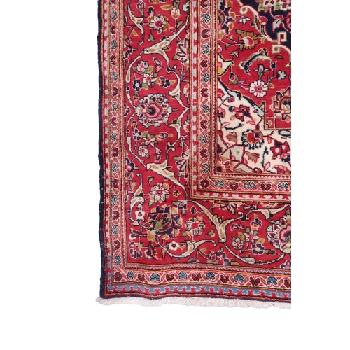 2124 - A DARK BLUE GROUND KESHAN RUG with terracotta and cream diamond form central medallion and matc... 