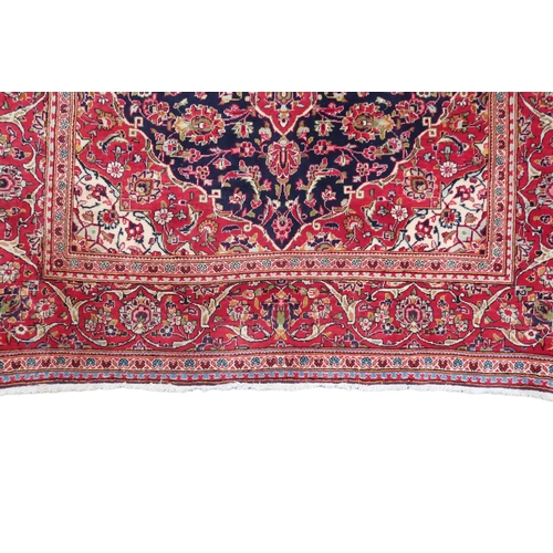 2124 - A DARK BLUE GROUND KESHAN RUG with terracotta and cream diamond form central medallion and matc... 