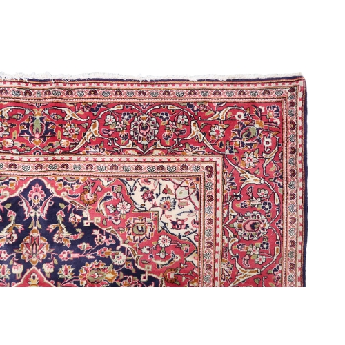 2124 - A DARK BLUE GROUND KESHAN RUG with terracotta and cream diamond form central medallion and matc... 